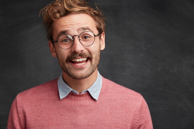 Young man with beard and round glasses