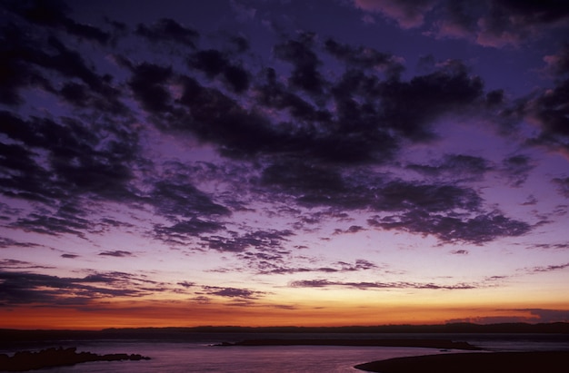 Purple Sky with Clouds Above the Sea at Sunset