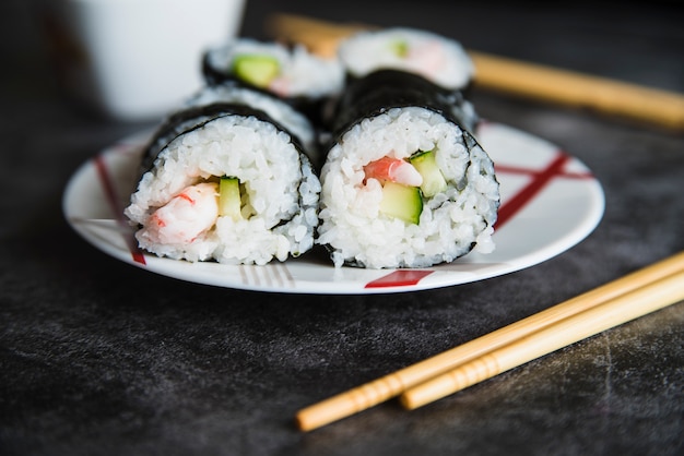 Composition of Sushi Rolls on Plate and Chopsticks – Free Download