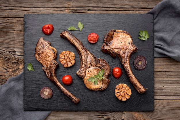 Cooked Meat and Vegetables on a Wooden Board – Free Download