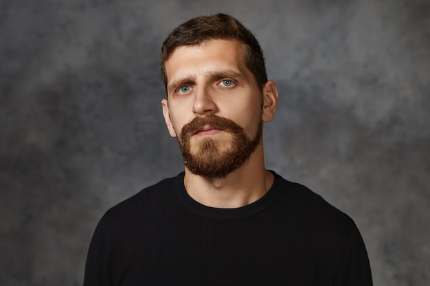 Serious Handsome Caucasian Man with Blue Eyes and Beard Posing Against Blank Wall – Free Stock Photo, Download for Free