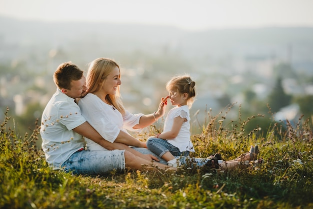 Happy Parents and Their Little Girl Enjoying a Beautiful Summer Day – Free to Download