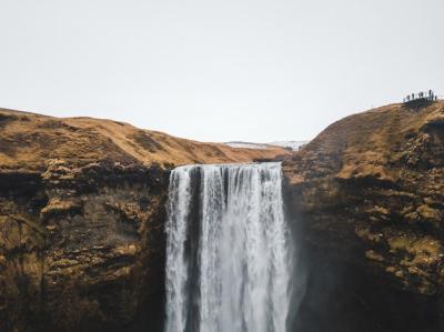 Stunning Waterfall Cascading from Arid Brown Mountain – Free Download