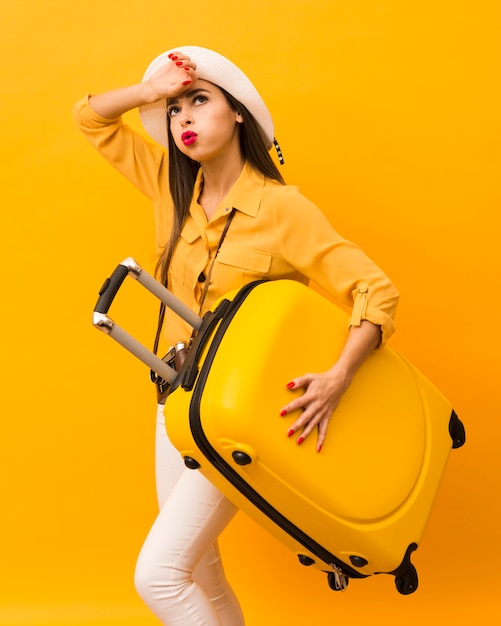 Exhausted Woman Holding Luggage from Trip – Free Download