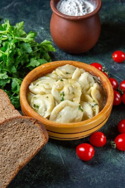 Meat Dumplings with Fresh Cherry Tomatoes and Greens on Dark Surface – Free Download