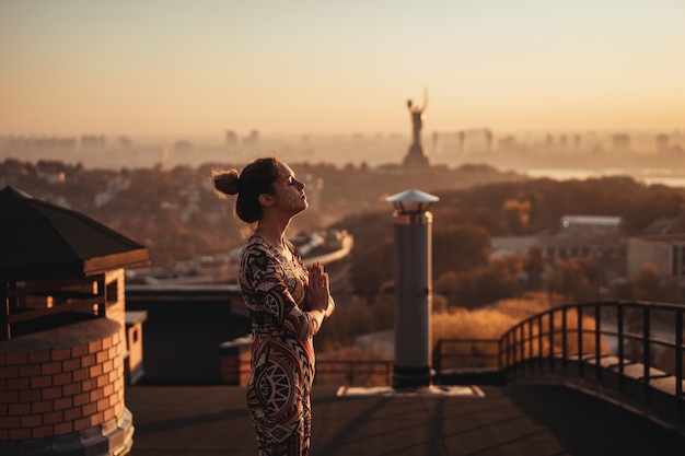 Yoga Poses on Skyscraper Rooftop in a Big City – Free Download