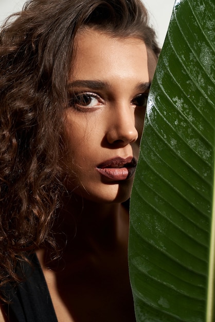 Stylish Woman Hiding Face Behind a Big Green Leaf – Free Stock Photo, Download for Free