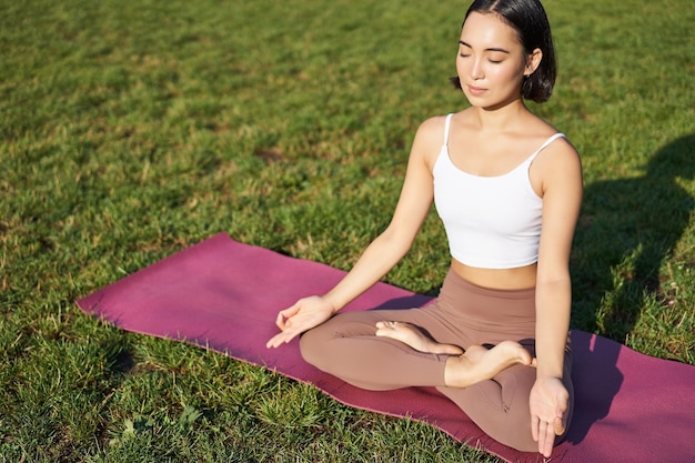 Smiling Asian Woman Meditating in Nature – Free Stock Photo for Download