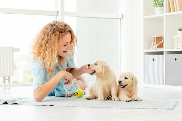 Girl Playing with Retriever Puppies – Free Stock Photo for Download