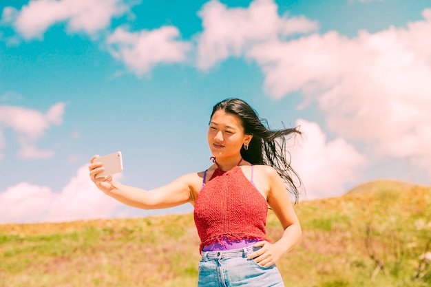 Asian Woman Taking Photos in a Field – Free Stock Photo, Download for Free