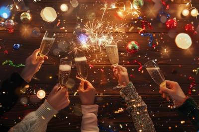 New Yearâs Eve Celebration with Fireworks, Champagne, and Confetti on Warm Wooden Background – Free Download