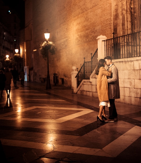 Elegant Couple Sharing Affection on the Street – Free Stock Photo for Download