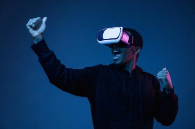 Young Man Playing in VR Glasses Under Neon Lights – Free Download