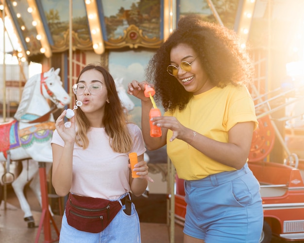 Teenagers Enjoying Bubbles at the Amusement Park – Free Download