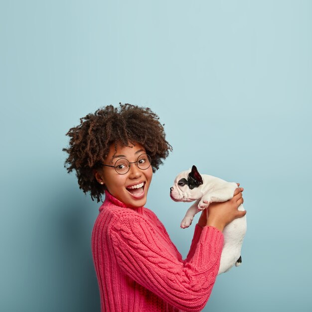 Young Woman with Afro Haircut Holding Puppy – Free Stock Photo for Download