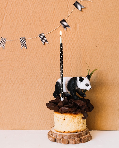 Panda Statuette and Candle on Blank Cardboard – Download Free Stock Photo