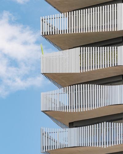 Grey Concrete Building with White Metal Railings Under Blue Sky – Free Download