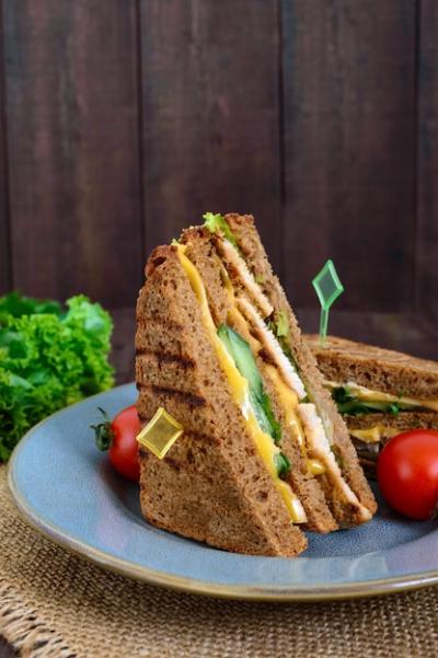 Delicious Club Sandwich with Rye Bread, Chicken, Cheese, Cucumbers, and Greens – Free Download