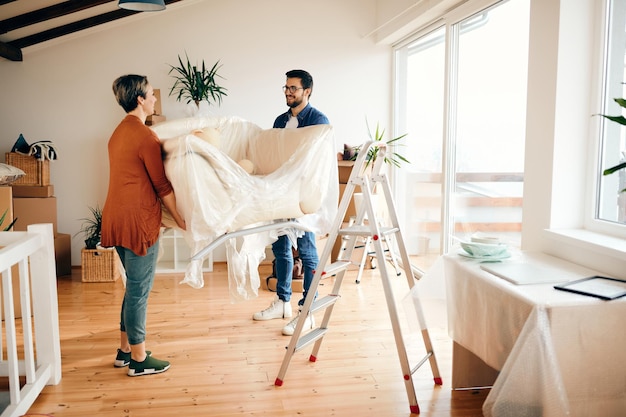 Happy Couple Moving a Sofa into Their New Apartment – Free Stock Photo, Download Free