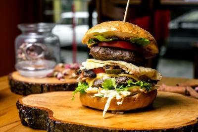 Side View of a Delicious Meat Burger with Tomato, Cucumber, Egg, Coleslaw, Lettuce, Cheese, and Olives – Free Download