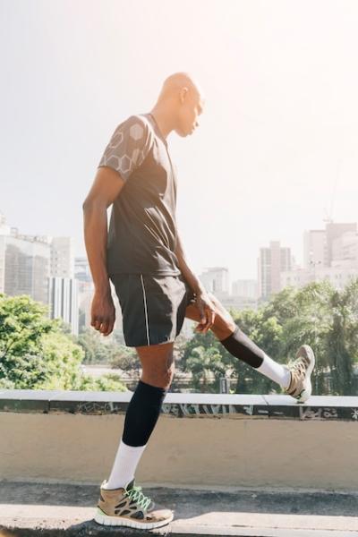 African Athlete Young Man Stretching Leg on Rooftop in the City – Free Stock Photo, Download Free