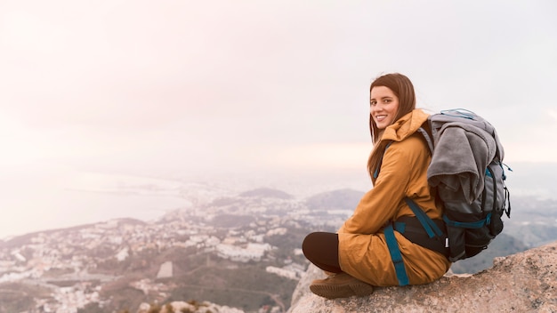 Smiling Young Woman at Mountain Summit – Free Stock Photo for Download