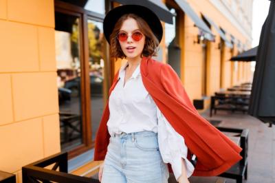 Young Elegant Woman in Orange Jacket and White Blouse Walking in Sunny City – Free Download