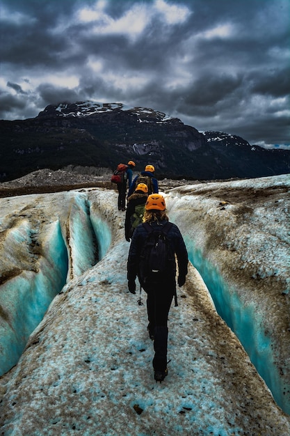 Hikers Walking on Rock Against Cloudy Sky – Free Stock Photo, Download Free