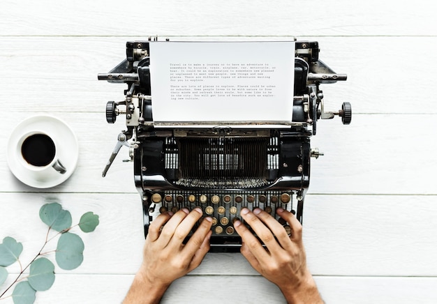 Aerial View of a Man Typing on a Retro Typewriter – Free Stock Photo for Download