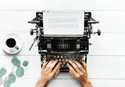 Aerial View of a Man Typing on a Retro Typewriter – Free Stock Photo for Download