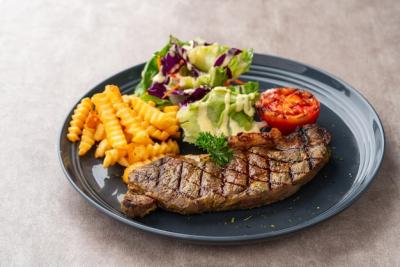 Grilled Sirloin Beef Steak with French Fries and Salads on Black Plate – Free Stock Photo