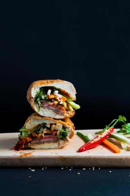 Close-Up of Sandwiches on Cutting Board Over Black Background – Free Stock Photo for Download