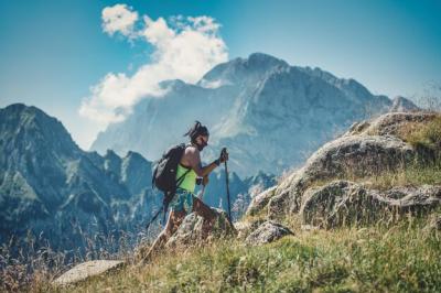 Man Climbing on Mountain Against Sky – Free Stock Photo for Download