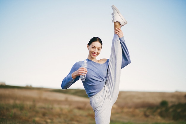 Cute Young Woman Training with Water Bottle – Free Download