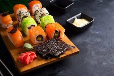 Asian Food Background Featuring Black Iron Teapot and Sushi Set on Wooden Plate – Free Download