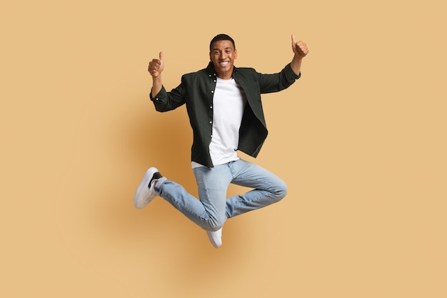 Happy Black Man Jumping and Giving Thumbs Up – Free Download
