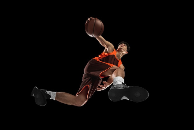 Young Professional Basketball Player in Action on Black Background – Free Download