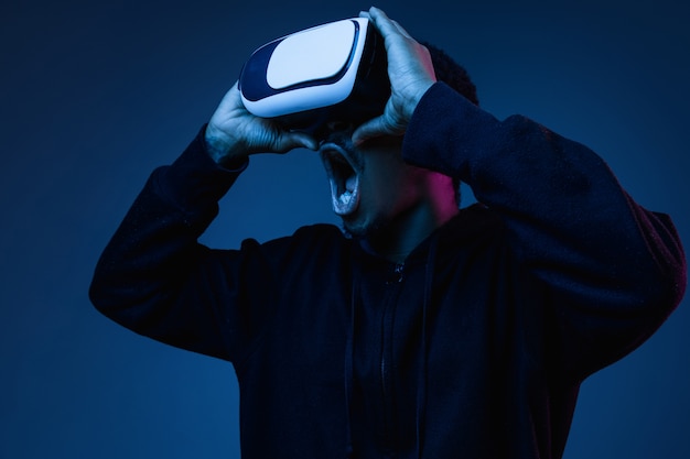 Young Man Playing in VR Glasses Under Neon Lights – Free Download