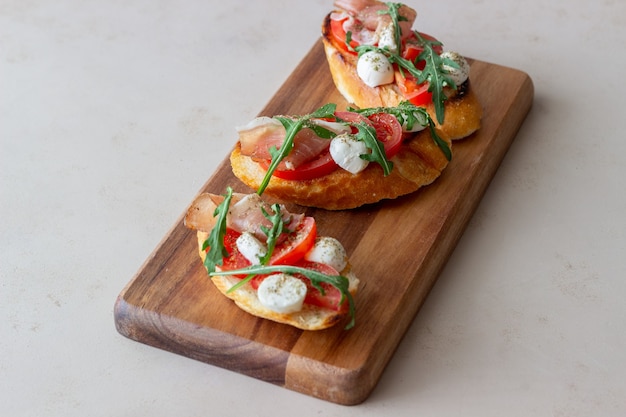 Bruschetta with Ham, Mozzarella, Tomatoes, and Arugula – Wine Appetizer Snack – Free Download