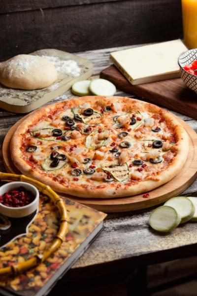 Delicious Pizza Capricciosa on the Table – Free Download