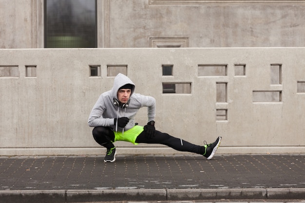 Athlete Stretching in Urban Environment – Free Download