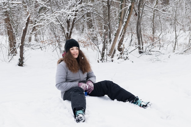 Girl in Warm Clothes Sitting on Snow – Free Download