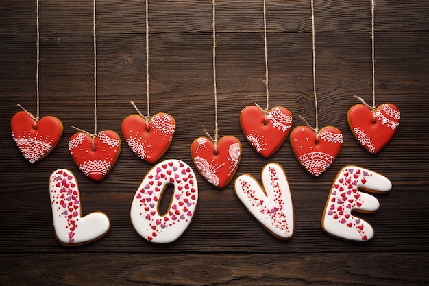 Heart-Shaped Cookies Forming the Word “Love” on a Rustic Wooden Table – Free Stock Photo for Download