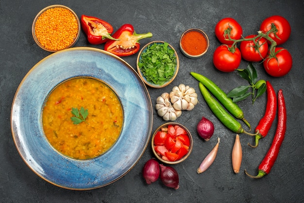 Top View of Lentil Soup Next to Colorful Vegetables – Free Download