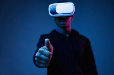 Young African-American Man in VR Glasses Surrounded by Neon Blue Light – Free Download