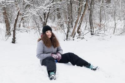 Girl in Warm Clothes Sitting on Snow – Free Download