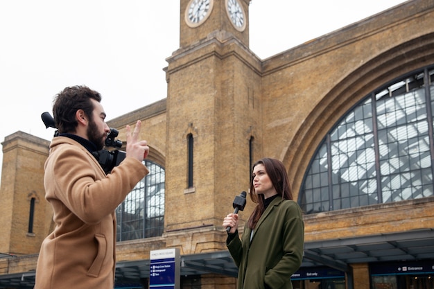 Medium Shot of a Man Recording a Woman – Free Download