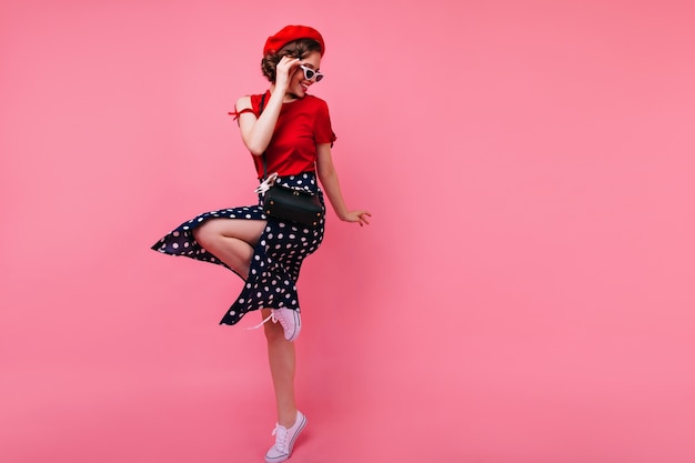 Excited Brunette Lady in Black Skirt Dancing Against Rosy Wall – Free Stock Photo, Download for Free