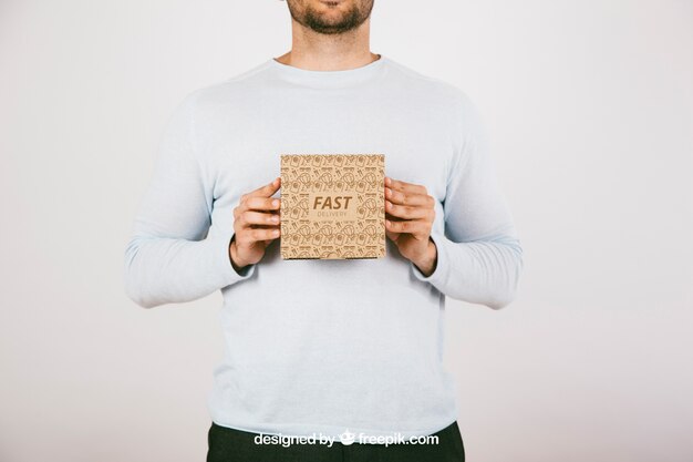 Man Holding a Carton Box Mockup – Free Download