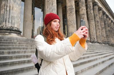 Redhead Girl Blogger Capturing Travel Moments on Smartphone – Free Download